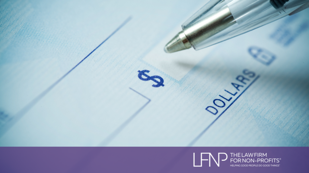 donor writing a chack to make a charitable donation to a nonprofit